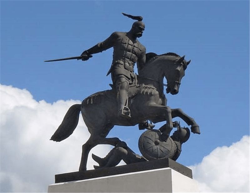statue of horse and rider against blue sky.